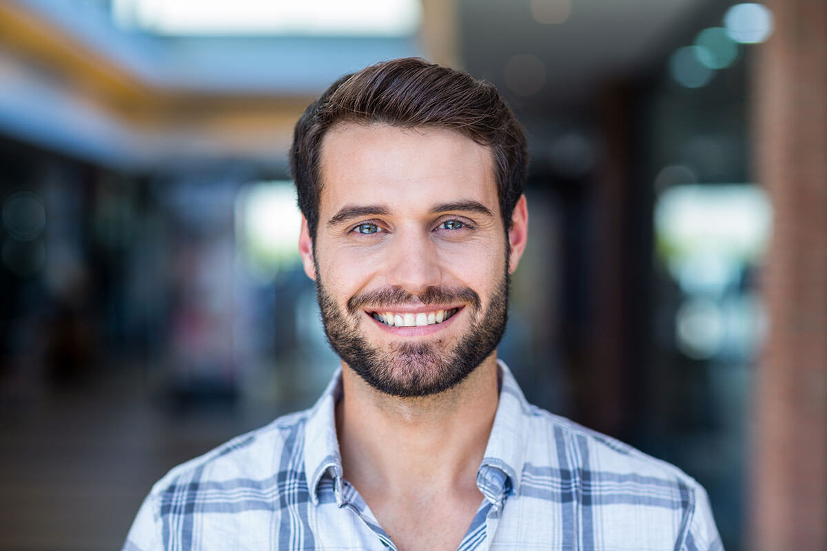man smiling after having mouth cancer screening test