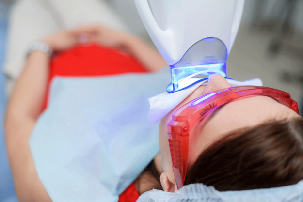 How-to-Get-Rid-of-Stained-Teeth a patient sits in dental exam chair asks how to get rid of stained teeth and then receives teeth whitening services
