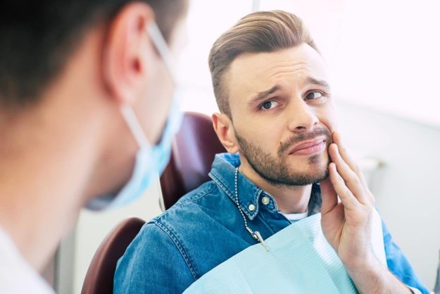 Dealing with Impacted Wisdom Teeth man dealing with impacted wisdom teeth