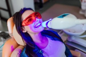 woman at dentist undergoing teeth whitening services