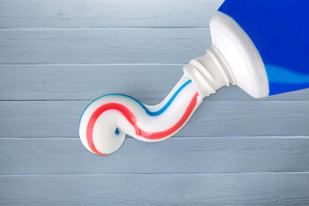 What Is The Best Toothpaste for Cavities toothpaste squeezed out of toothpaste tube on a surface while a dentist discusses the best toothpaste for cavities