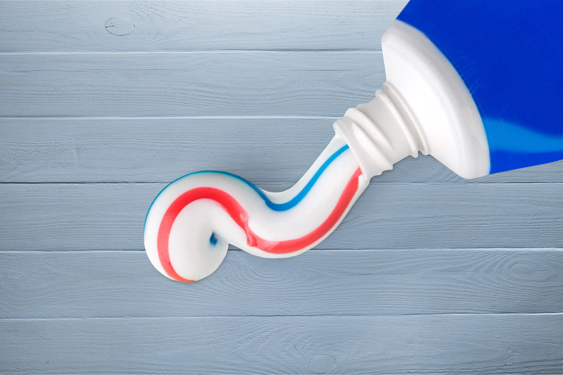 What Is The Best Toothpaste for Cavities toothpaste squeezed out of toothpaste tube on a surface while a dentist discusses the best toothpaste for cavities