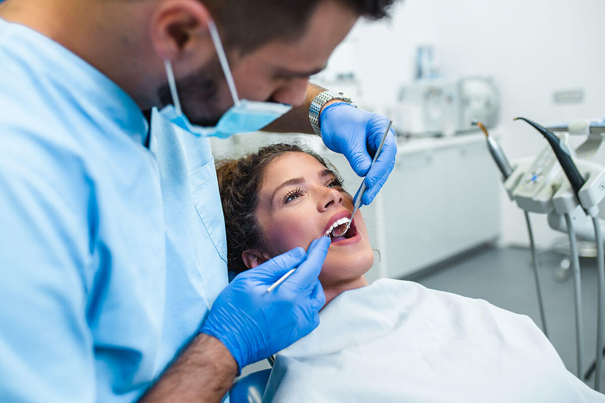 a dentist works on a patient's mouth to fix their periodontal pocket