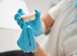 a dentist uses a model to explain crowns vs fillings to a patient