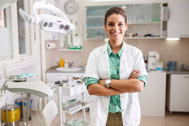 Finding A Family Dentistry In Houston, TX a dentist in family dentistry in houston tx smiles while standing in her office's dental exam room